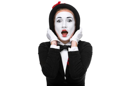 Portrait of the surprised woman as mime isolated on white background.の写真素材