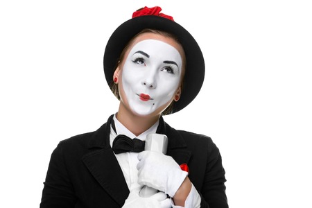 business woman as mime holding a handset isolated on white background. Concept of the joy of hearing the newsの写真素材