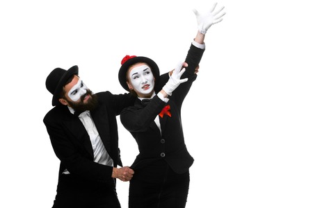 Mime holding another one up and running, isolated on white background. Concept of career and ambition of a businessmanの写真素材