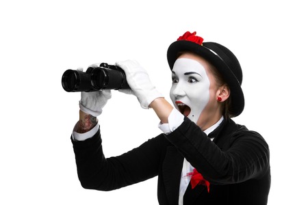 Portrait of the surprised and joyful woman as mime with binoculars isolated on white background. Concept unexpected and joyful discoveryの写真素材