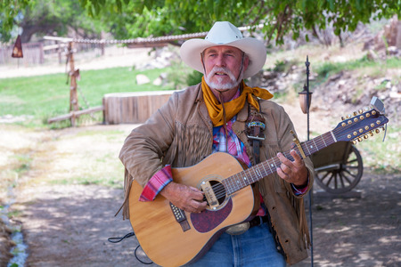 USA, Bartley Ranch Regional Park, Reno, Nevada - 14 MAY 2008. Aged man with a guitar on ranch backgroundのeditorial素材