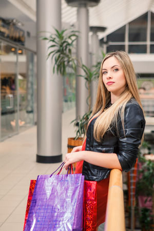 sale concept. beautiful young woman with a shopping bags in the mallの写真素材