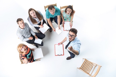Top view of business people in a meeting on white background. everyone is looking up and wonderingの写真素材