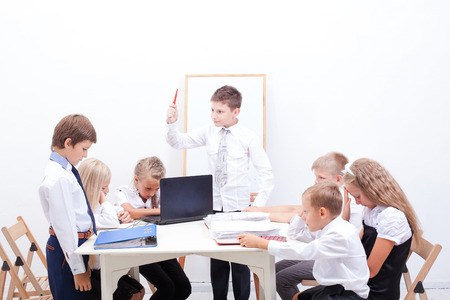 The group of teenagers sitting in a business meeting on white background. Chief berates an employeeの写真素材