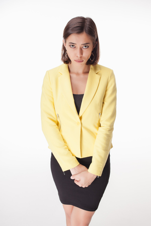The picture of modest business woman on white background in a yellow jacketの写真素材