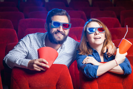 A variety of human emotions of friends holding a cola and popcorn in the cinema.の写真素材
