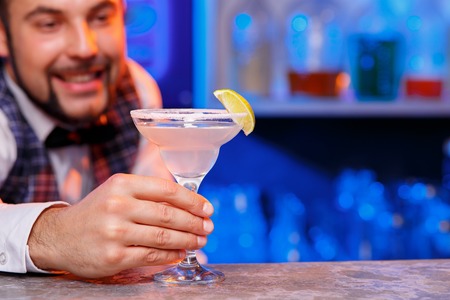 The smiling barman at work, he preparing cocktails. Concept about service and beverages.の写真素材