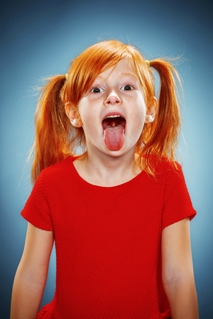 beautiful little girl tongue" The beautiful portrait of a little girl with his tongue hanging out with  red hair in red dress on blueの素材 [FY31052813866] | ストックフォトの Qlean  Market（キュリンマーケット）