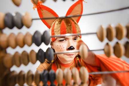 The young woman in the image of red squirrel with abacus. The school and education conceptの写真素材