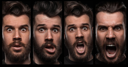 Set of young man's portraits with different emotions on black backgroundの写真素材