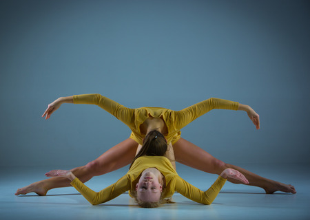 The two modern ballet dancers  posing on gray backgroundの写真素材