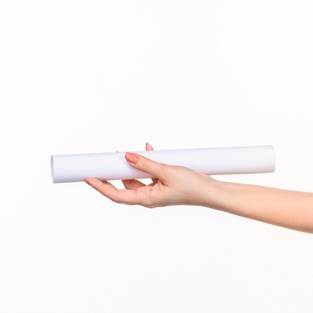 The white cylinder of the props in the female hands on white background with  right shadowの写真素材