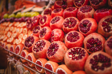 Colourful picture of oranges and pomegranates on the marketの写真素材