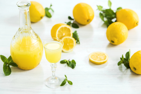 The italian traditional liqueur limoncello with lemonの写真素材