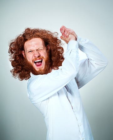 The young angry man with long red hair