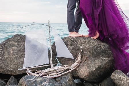 The wedding day at the sea. Young romantic couple on the beachand wedding ship