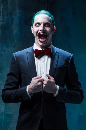 Bloody Halloween theme: The crazy joker face on black backgroundの写真素材