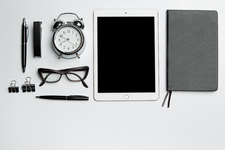 Office desk table with laptop, supplies, phone and coffee cup. Top view with copy spaceの写真素材