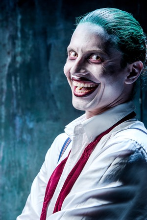 Bloody Halloween theme: The crazy joker face on black background