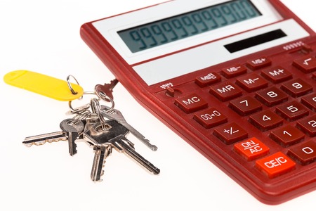 The red calculator with a keys on the white backgroundの写真素材