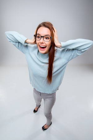 Smiling young business woman in glasses on a gray background. Top viewの写真素材