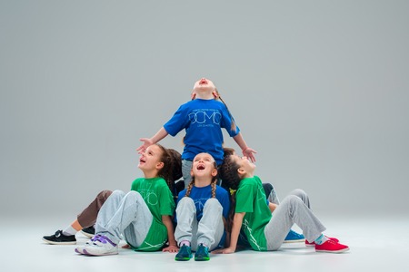 The kids dance school, ballet, hiphop, street, funky and modern dancers on gray studio backgroundの写真素材
