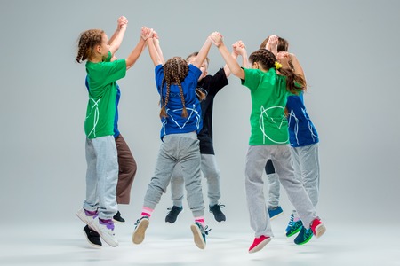 The kids dance school, ballet, hiphop, street, funky and modern dancers on gray studio backgroundの写真素材