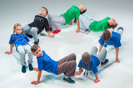 The kids dance school, ballet, hiphop, street, funky and modern dancers on gray studio backgroundの写真素材