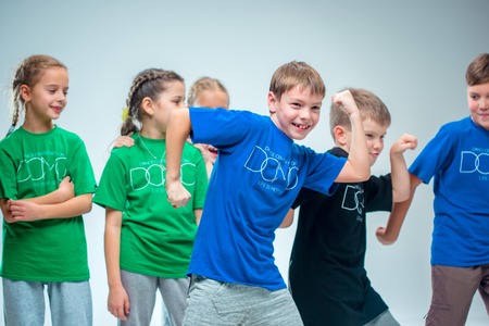 The kids dance school, ballet, hiphop, street, funky and modern dancers on gray studio backgroundの写真素材