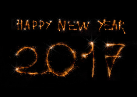 The text Happy New Year 2017 made of sparklers on black backgroundの写真素材