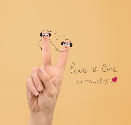 happy couple in love with painted faces in headphonesの写真素材