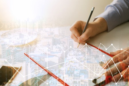 The male hand drawing a graph of growthの写真素材