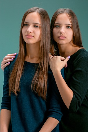 Portrait of two beautiful twin young womenの写真素材