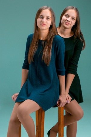 Portrait of two beautiful twin young womenの写真素材