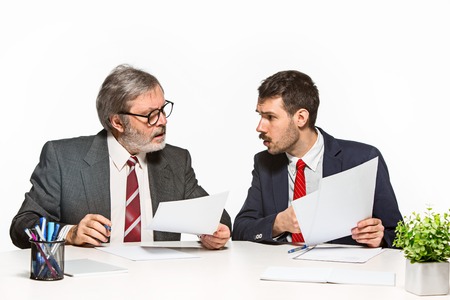 The two colleagues working together at office on white background.