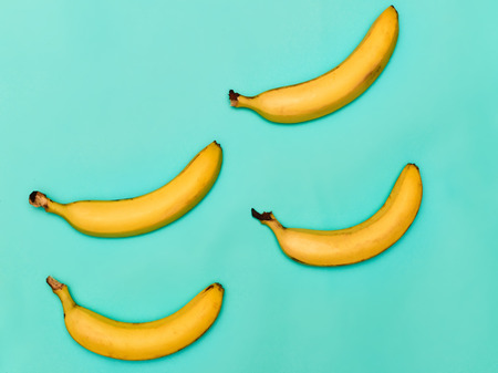The group of bananas against blue backgroundの写真素材