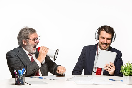 The two colleagues working together at office on white background.