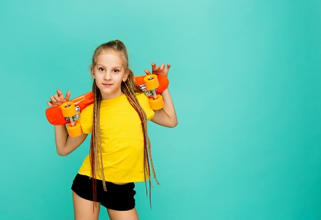 Pretty skater girl holding skateboardの写真素材