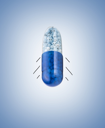 Blue capsules and pills backgroundの写真素材