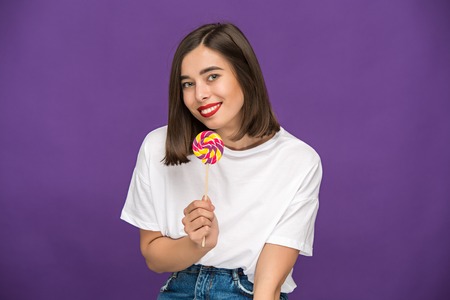 The young woman with colorful lollipopの写真素材