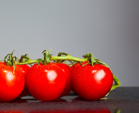 The fresh cherry tomatos on gray backgroundの写真素材