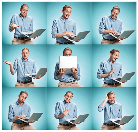 The smiling young man in a blue shirt working on laptopの写真素材