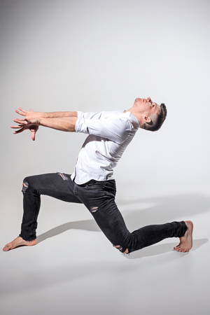 The young man dancing on grayの写真素材