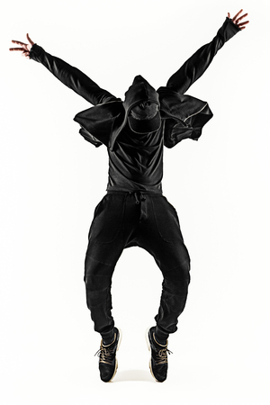 The silhouette of one hip hop male break dancer dancing on white backgroundの写真素材