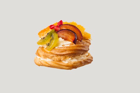 Closeup of cake with fresh fruits on gray background.の写真素材