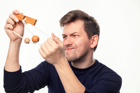 Attractive 25 year old business man looking confused at wooden puzzle.の写真素材