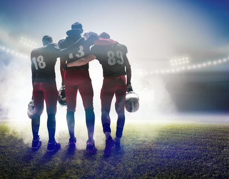 The three american football players on on stadium backgroundの写真素材