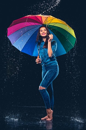 Young beautiful woman with an umbrella.の写真素材