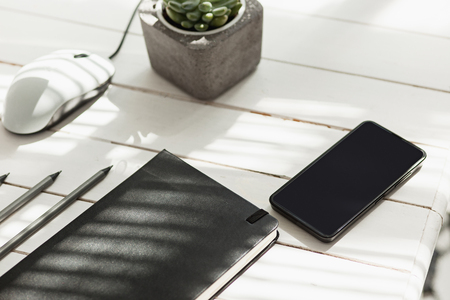 Office desk table with computer, supplies and phoneの写真素材