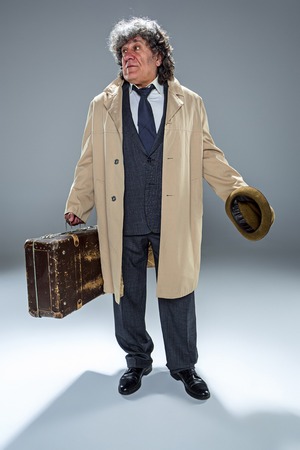 The senior man as detective or boss of mafia on gray studio backgroundの写真素材
